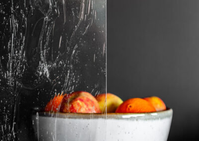 Bowl of fruits behind winterlake glass